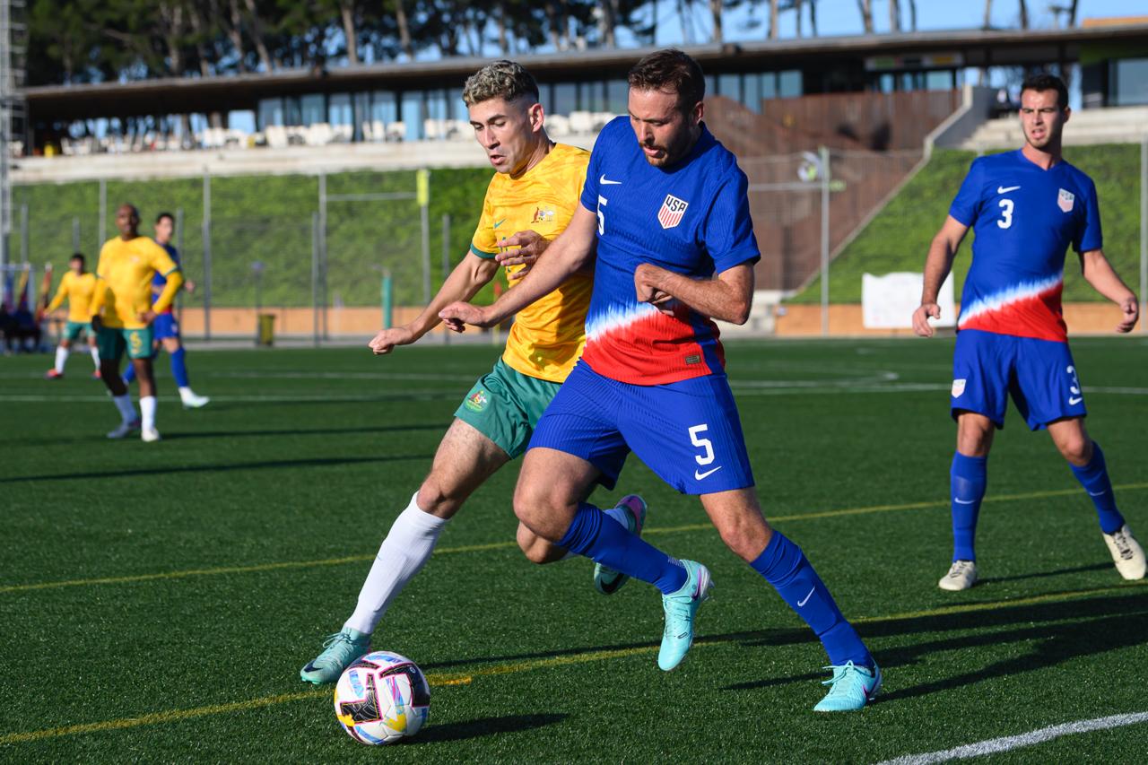 Augustine Murphy clases with a USA defender